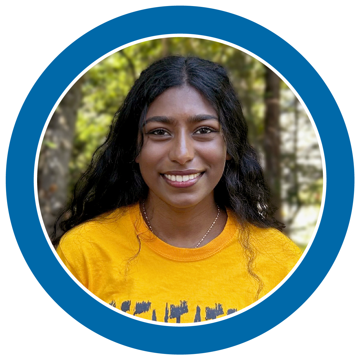 An student leader smiling with wearing a yellow shirt.